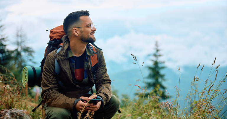 Smiling hiker taking in a mountain view, TMS therapy success rate and response rates explained
